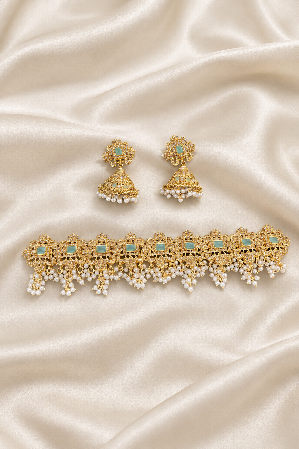 Gold choker and earrings on ivory silk