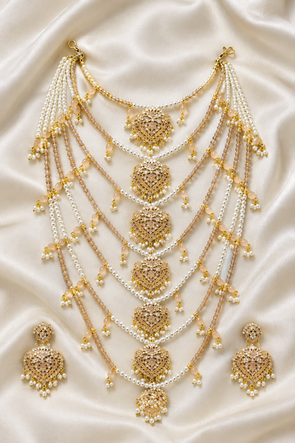 Jewellery set laid flat on ivory silk