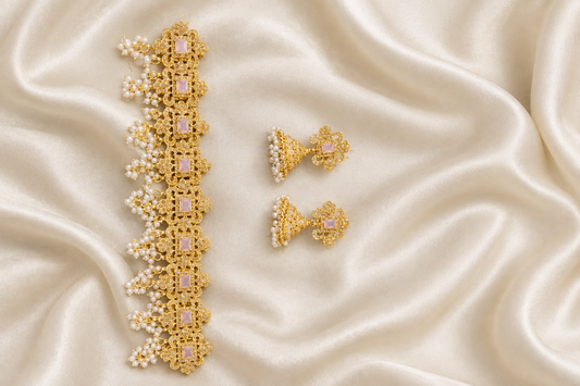 Gold jewellery and earrings on ivory silk