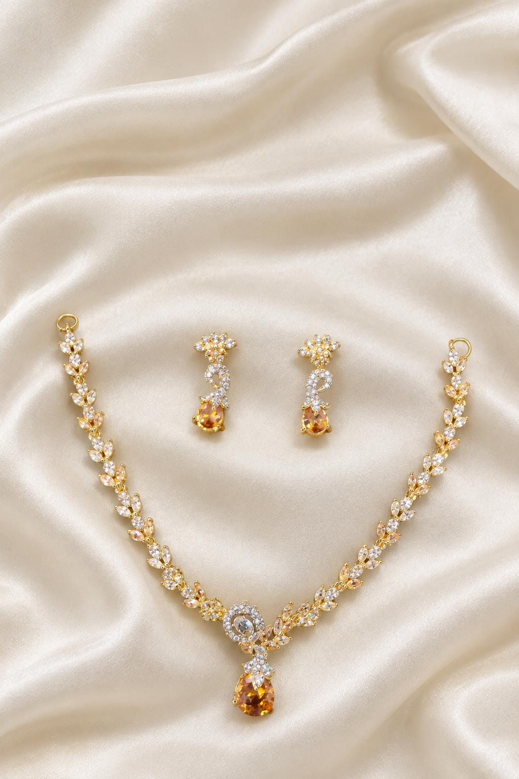 Necklace and earrings on ivory silk